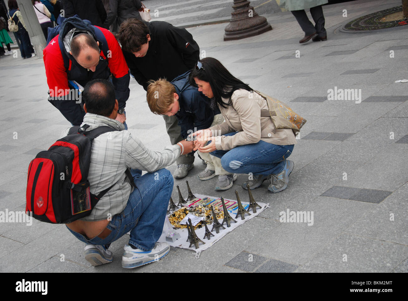 street vendor selling miniature Eiffel Towers to tourists Paris France Stock Photo