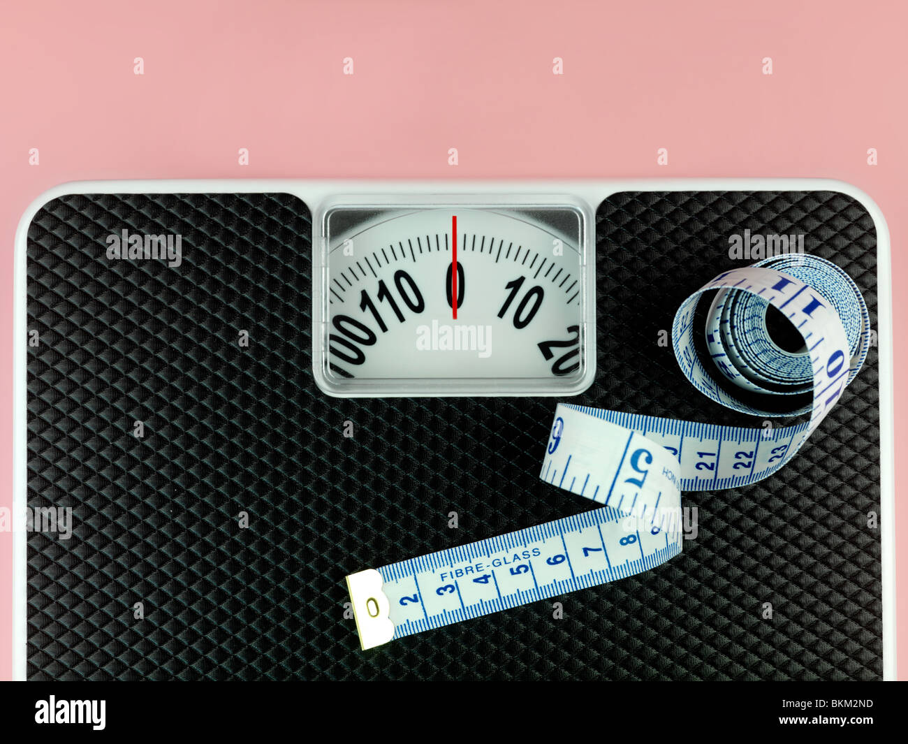 https://c8.alamy.com/comp/BKM2ND/a-set-of-bathroom-scales-isolated-against-a-pink-background-BKM2ND.jpg