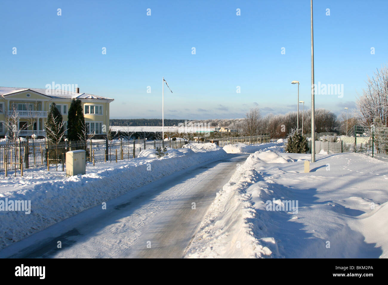 Beautiful empty winter road in a cold sunny day, near city of Tallinn in Estonia Stock Photo