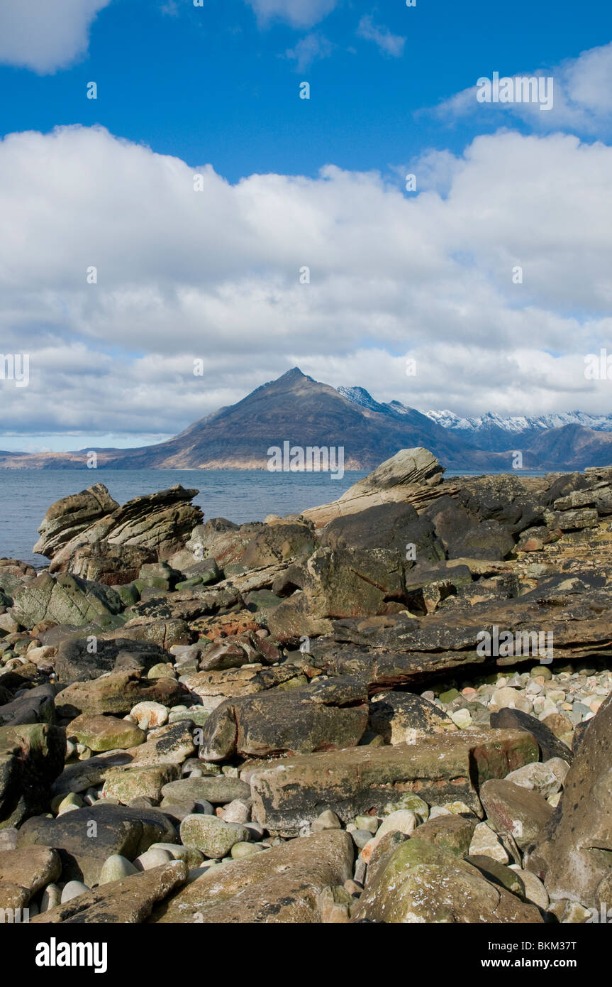 from the beach at Elgol with rock formations looking over Loch Scavaig to the Cuillin Hills  and Gars-bheinn Isle of Skye Highla Stock Photo