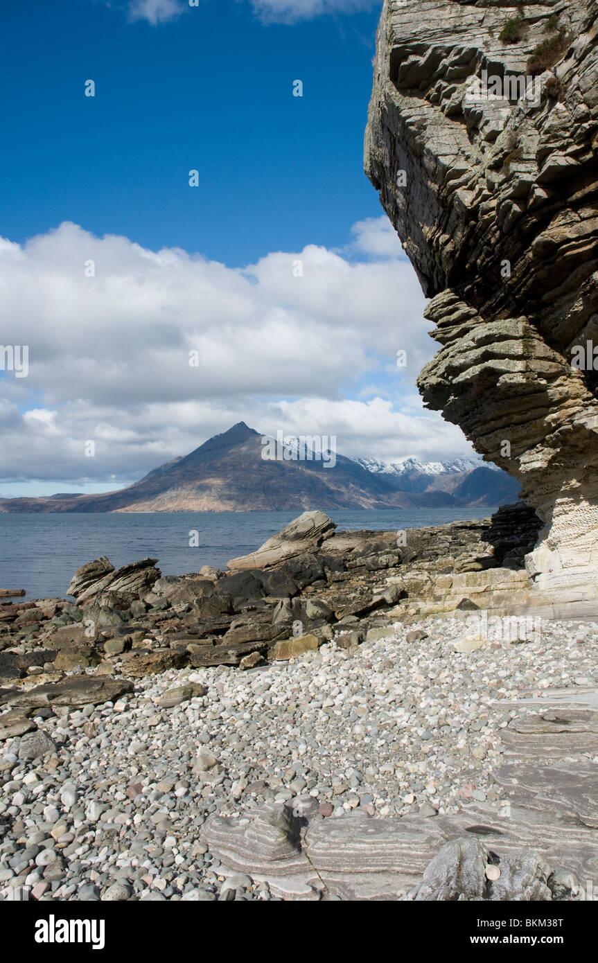 from the beach at Elgol with rock formations looking over Loch Scavaig to the Cuillin Hills  and Gars-bheinn Isle of Skye Highla Stock Photo