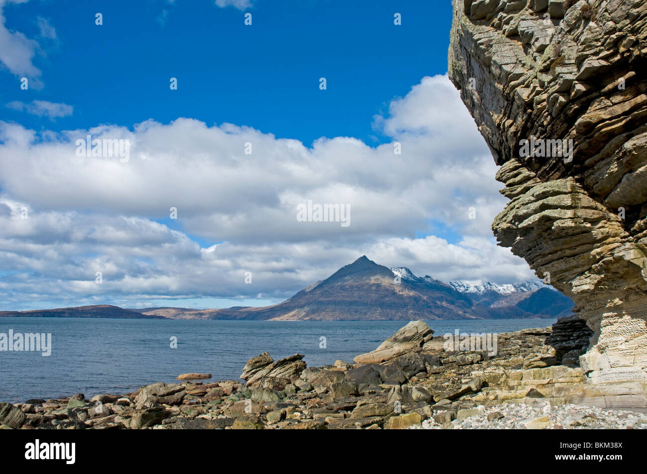 from the beach at Elgol with rock formations looking over Loch Scavaig to the Cuillin Hills  and Gars-bheinn Isle of Skye Highla Stock Photo