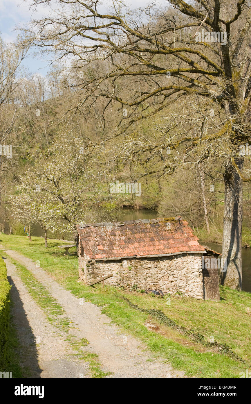 Stone Outbuilding with Red Tiled Roof Alongside Track and River Viaur at Port-de-la-Besse Aveyron France Stock Photo