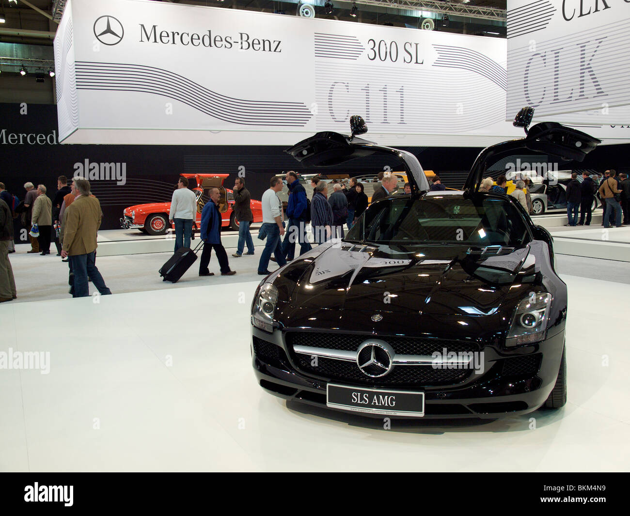 The new SLS AMG gullwing Mercedes on display at Techno Classica in Essen, Germany with red 300SL in the background. Stock Photo