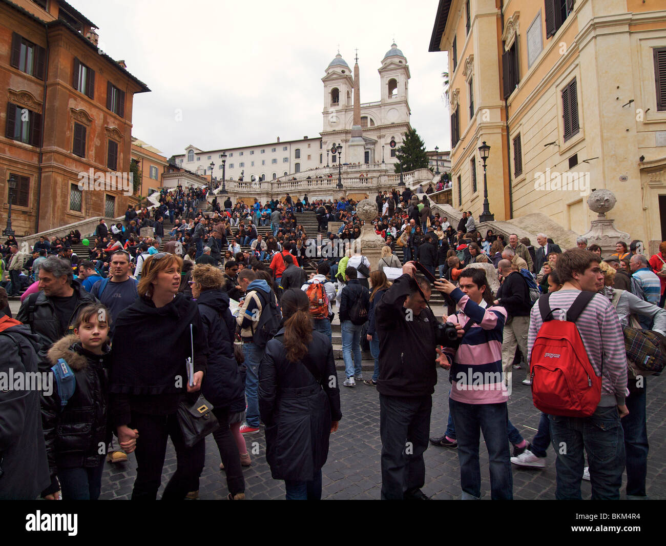 Trinita dei Monti with the Spanish Steps in Rome, Italy with many tourists people visiting Stock Photo
