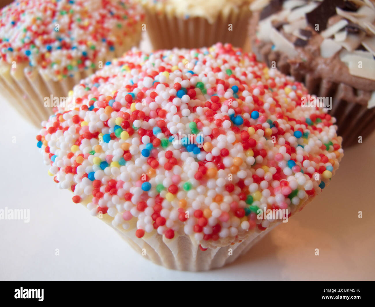 A cup cake covered in hundreds and thousands Stock Photo