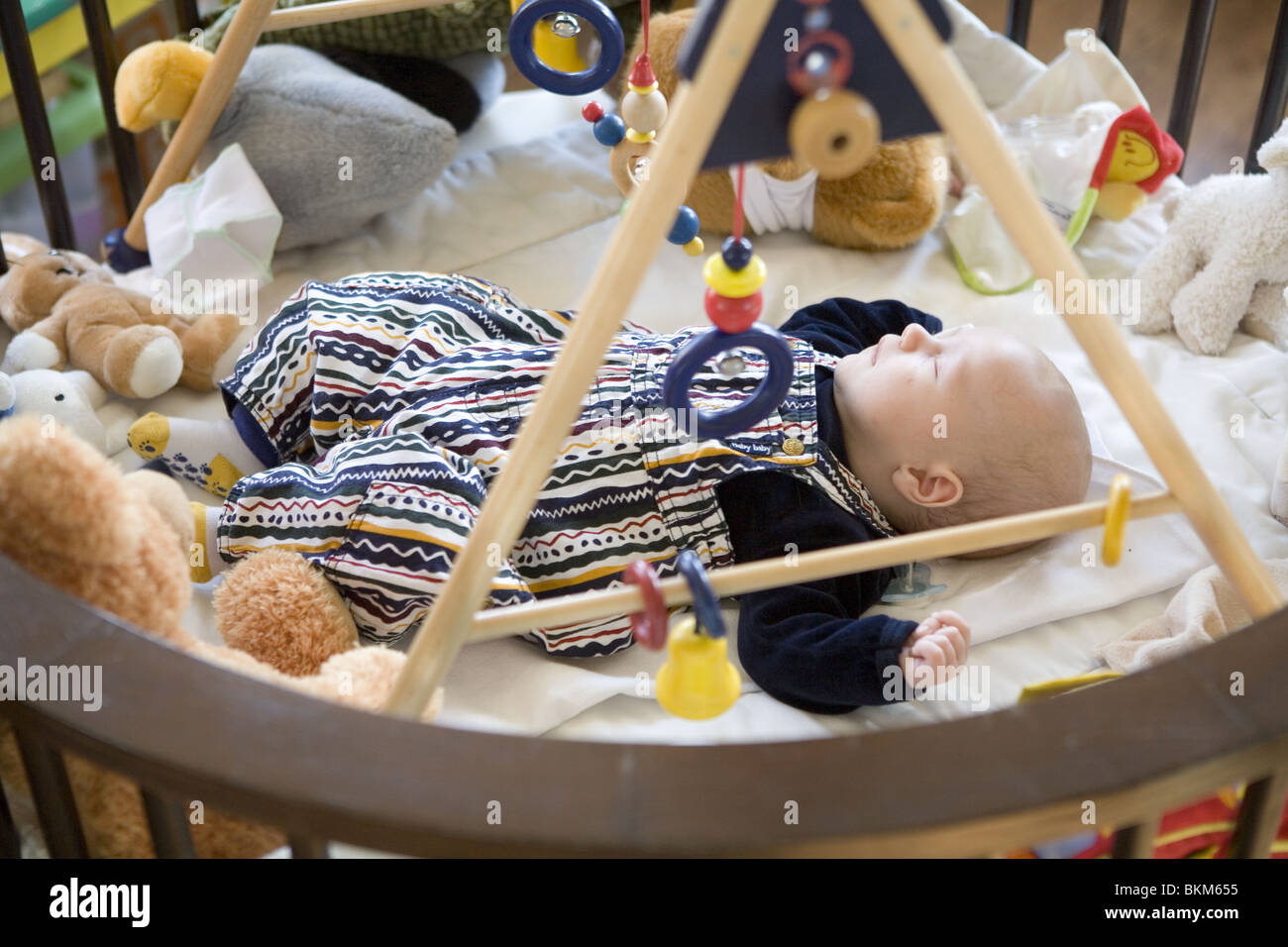 Baby sleeping in cot Stock Photo Alamy
