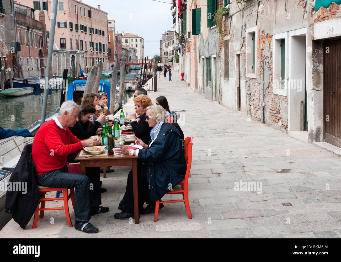 Small pavement restaurant beside canal in Cannaregio district of Venice Italy Stock Photo