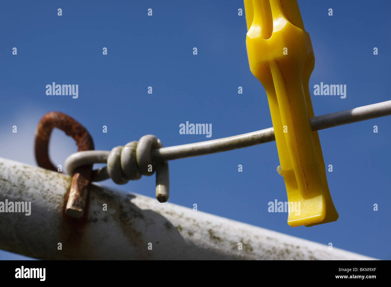 Close up of single clothes peg on washing line against blue sky Stock
