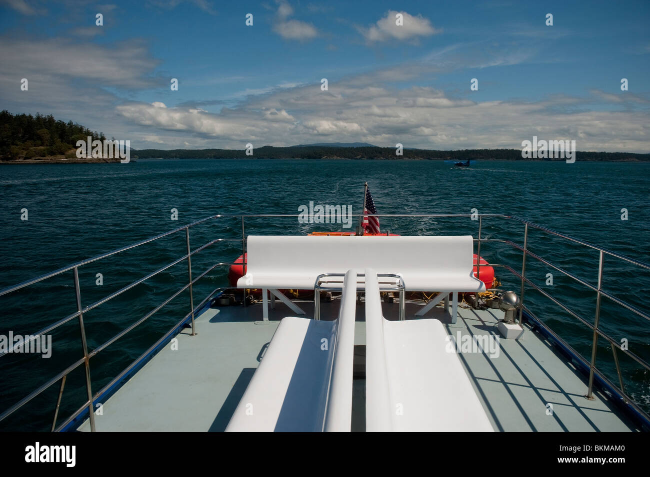 Cruising through the San Juan Islands in Puget Sound of northwest Washington state on a bright sunny day towards Orcas Island. Stock Photo