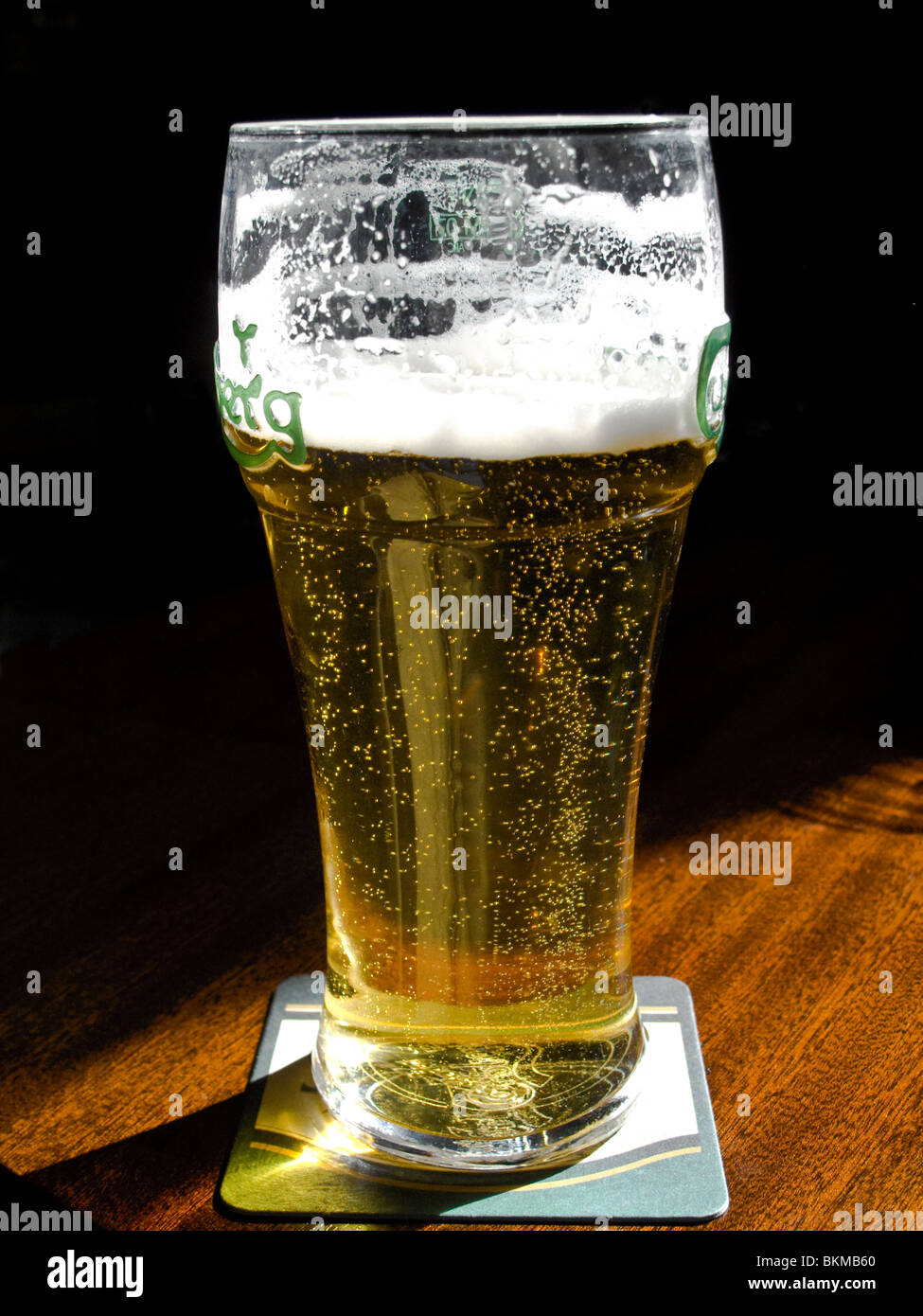 A pint glass of refreshing sparkling lager beer Stock Photo