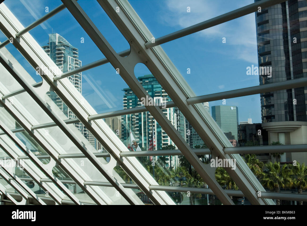 Buildings in downtown San Diego as seen through slanted glass wall in
