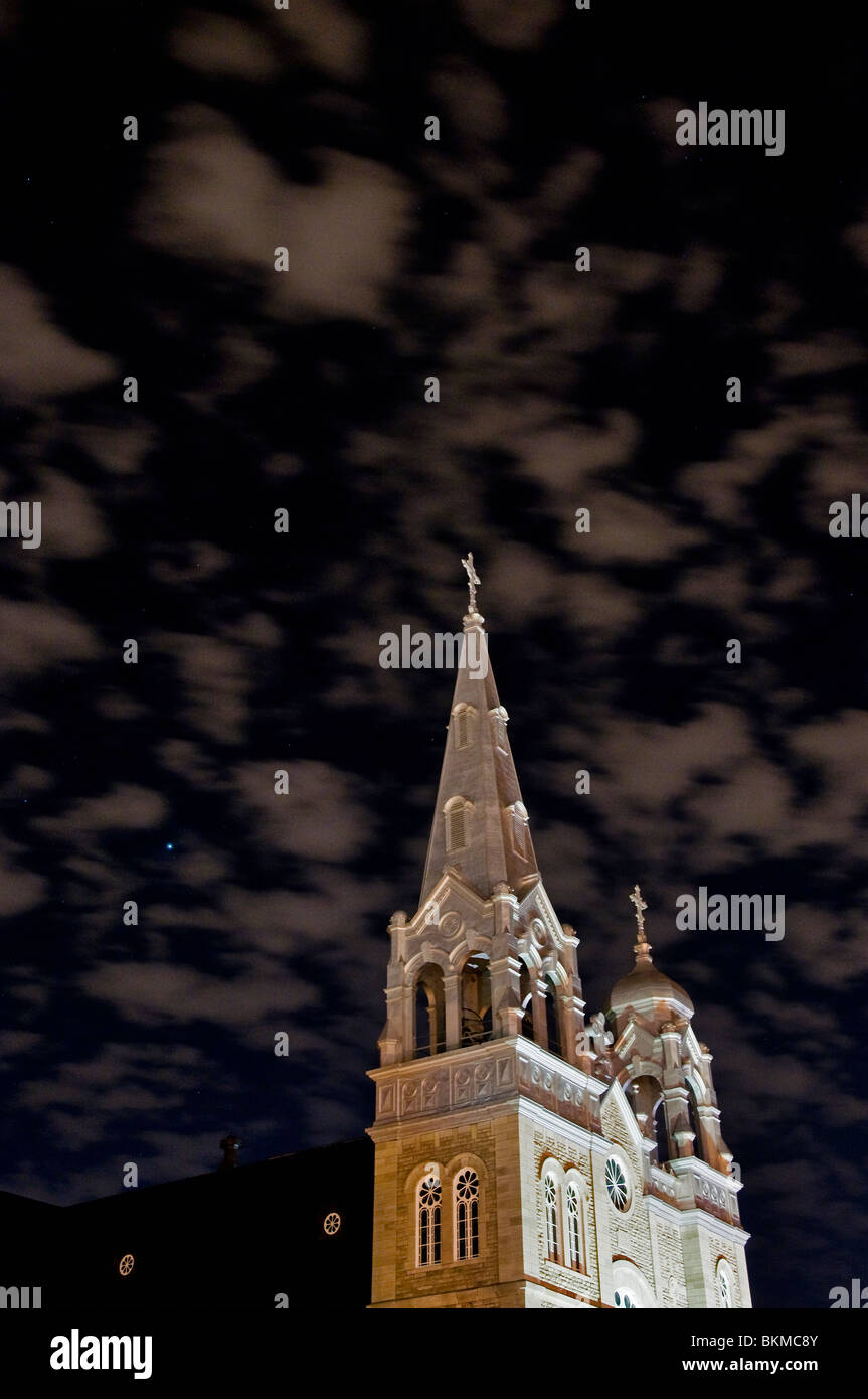 Night shot of a Catholic church with eerie sky. Stock Photo