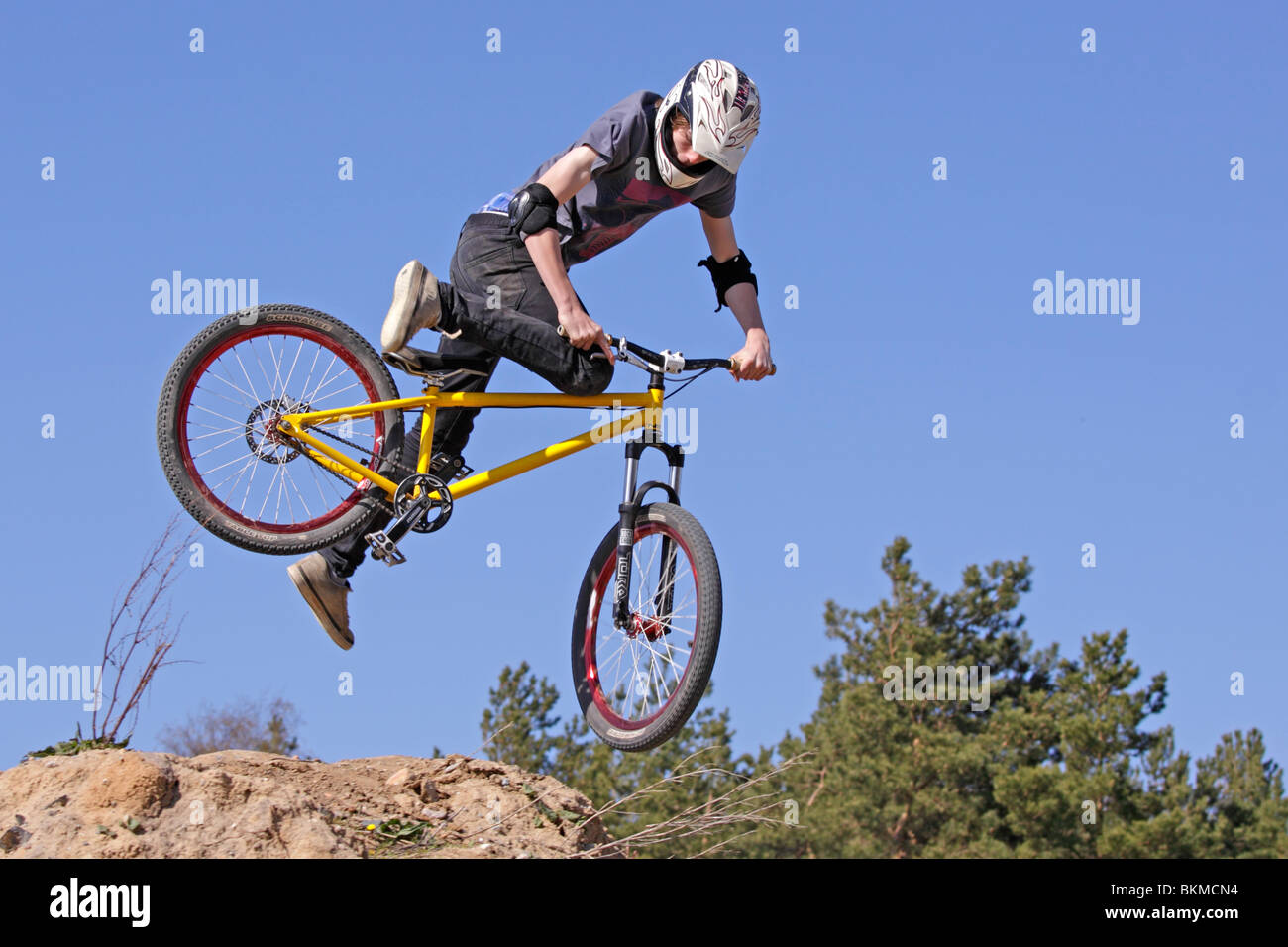 teenage boy jumping with his bike Stock Photo