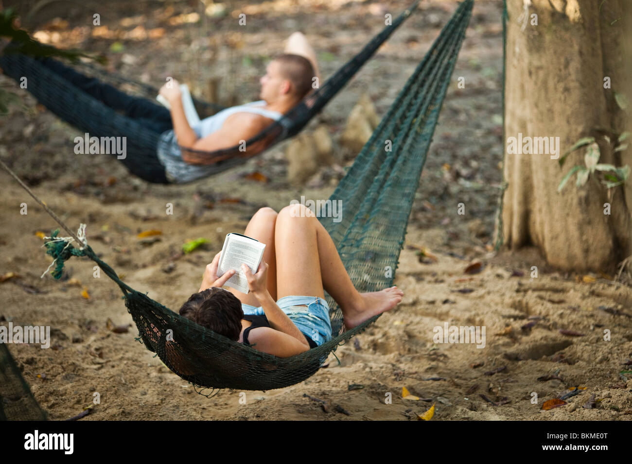 Tourists relaxing at an ecotourism jungle camp. Kinabatangan River, Sabah, Borneo, Malaysia. Stock Photo