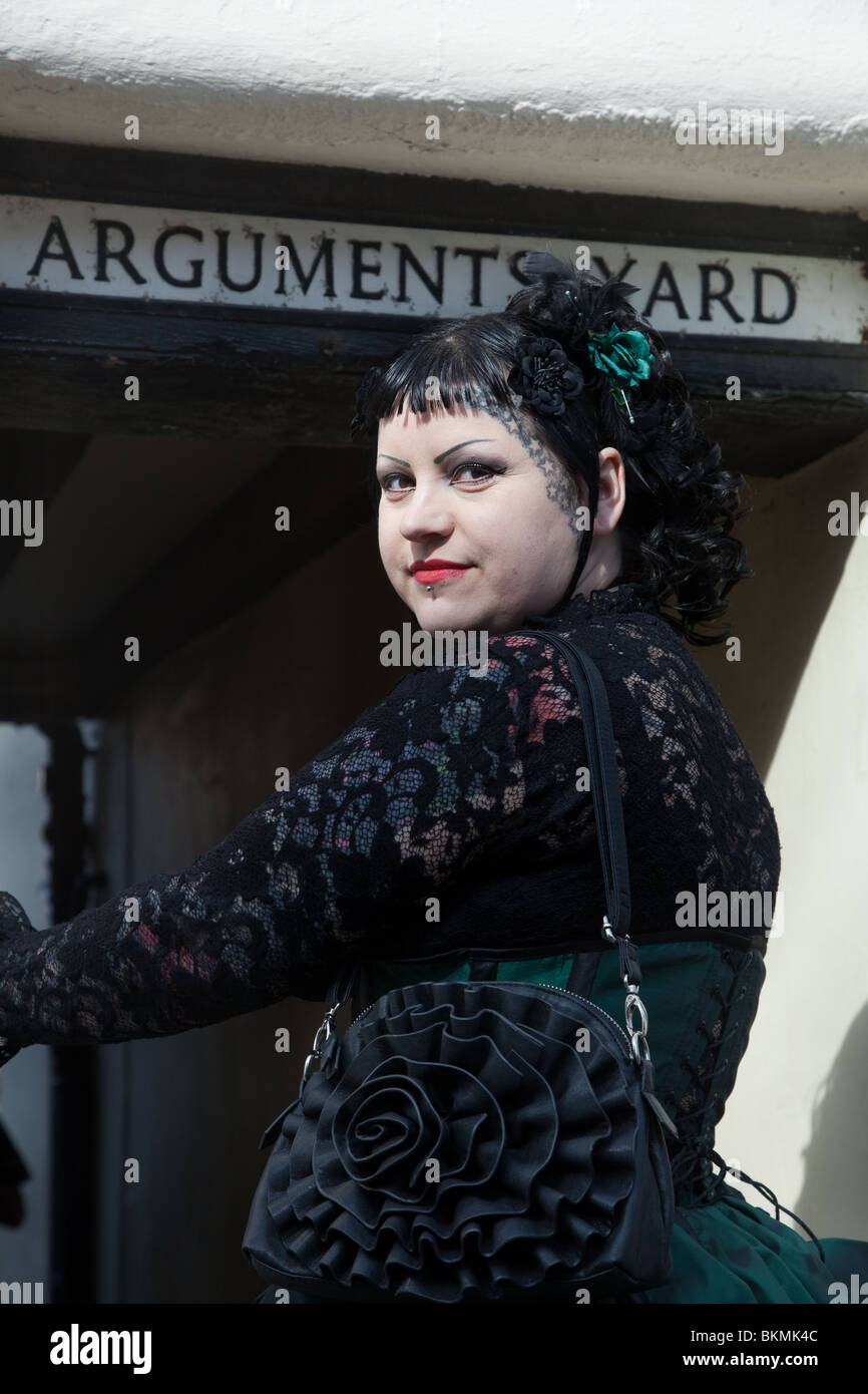 Woman entering Arguments Yard, at Goth Festival Whitby North Yorkshire, UK Stock Photo