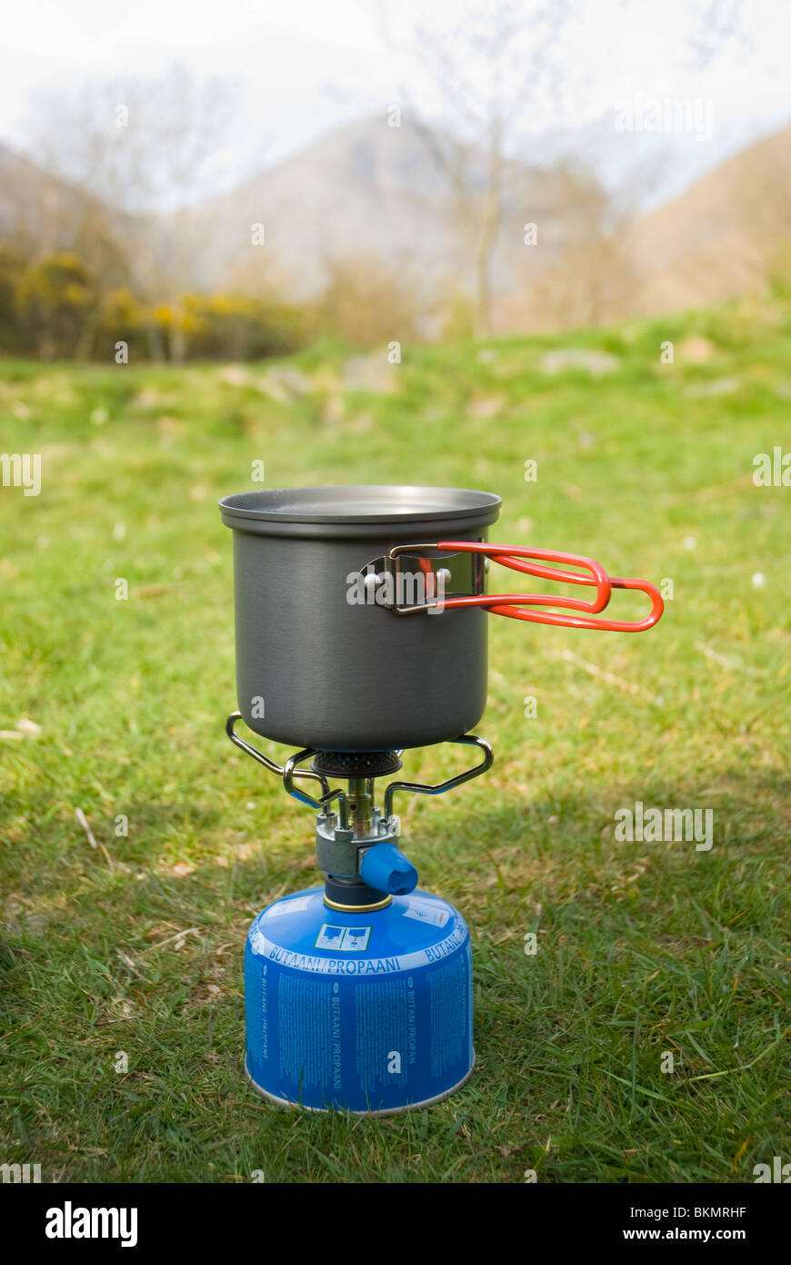 Miniature camping stove with saucepan at a campsite in the Lake district, with Great Gable in the background. Stock Photo