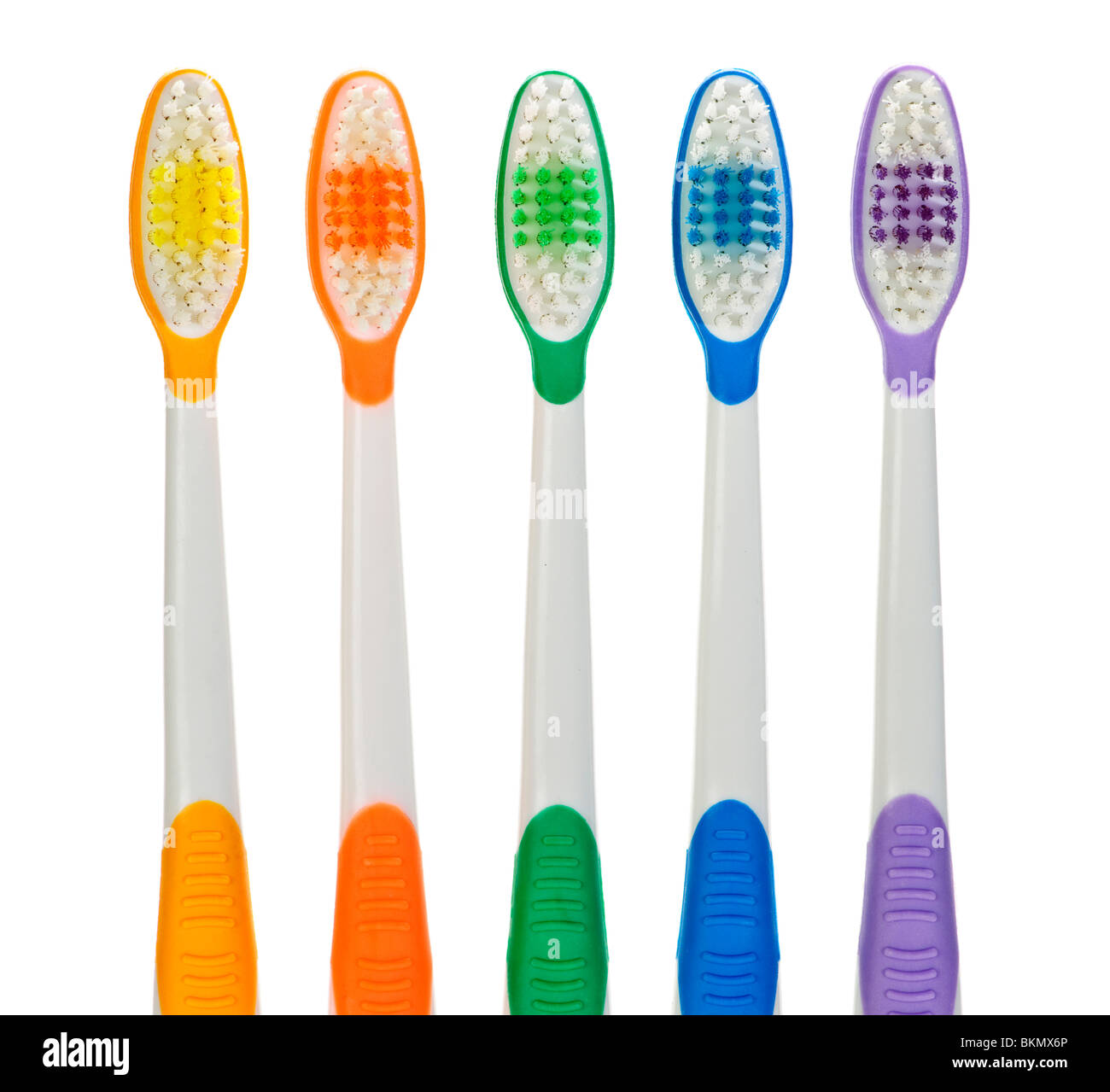 Close up of multicolored toothbrushes on white background Stock Photo