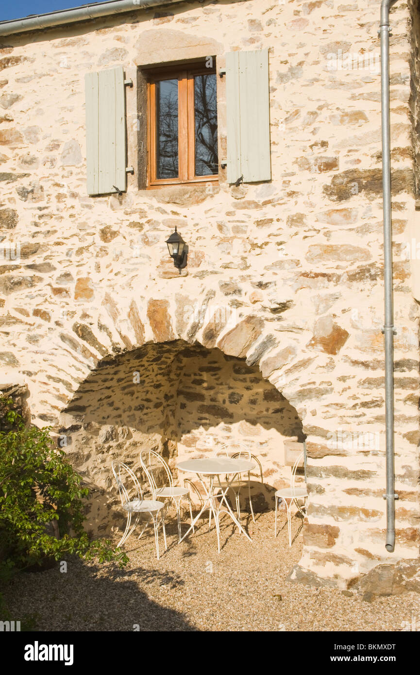A Sheltered Stone Arched Alcove with Picnic Table and Chairs in a Sunny