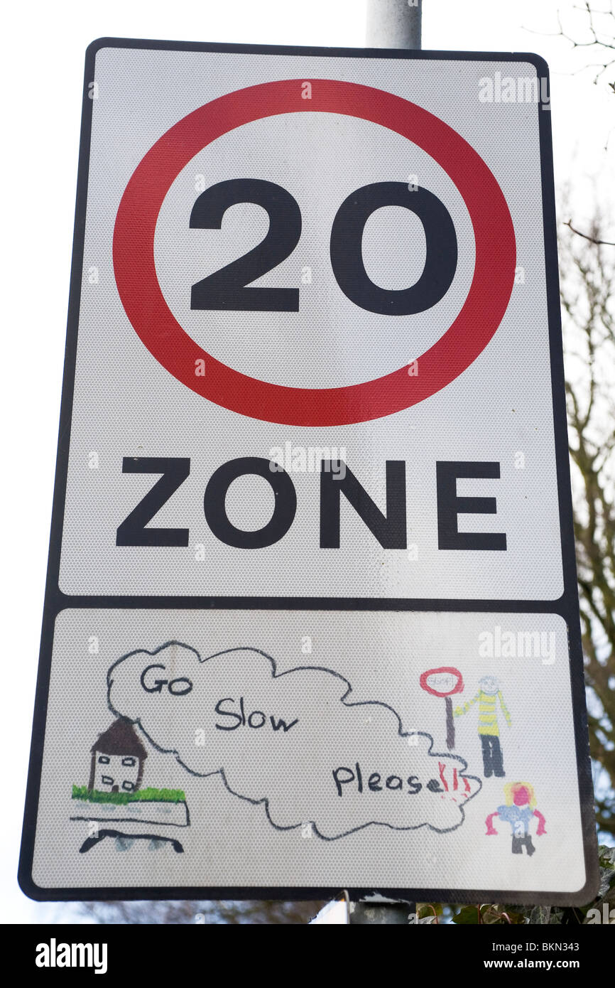 A sign warns drivers that the speed limit is just 20 miles per hour. Stock Photo