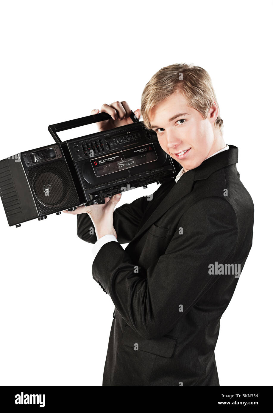 Blond handsome smiling young man holds stereo player in 1980s style Stock Photo