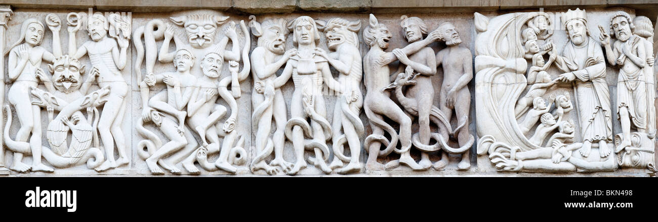 Devil at work, stone frieze, west entrance, Lincoln cathedral, England Stock Photo