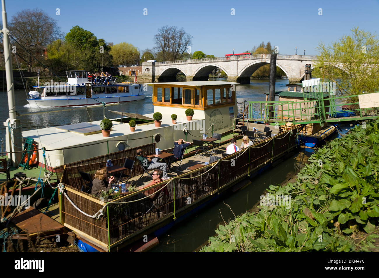 A floating boat cafe ('River Thames Visitor Centre & Cafe') moored near Richmond Bridge at Richmond upon Thames, Surrey. UK. Stock Photo