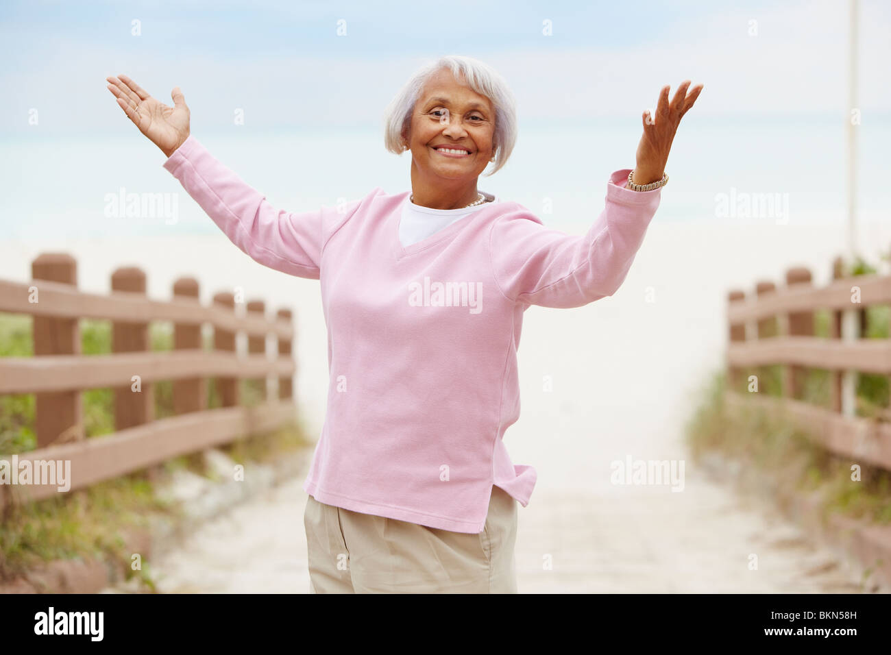 Senior African American woman with arms outstretched Stock Photo - Alamy