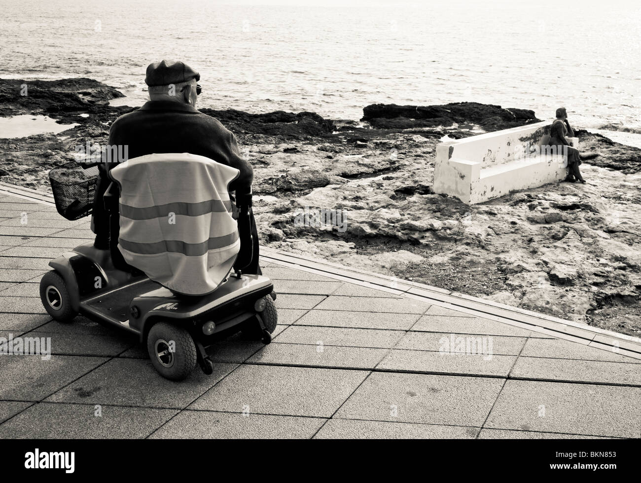 Disabled Spanish man on mobility scooter at Torrevieja seafront, Costa Blanca, Spain Stock Photo