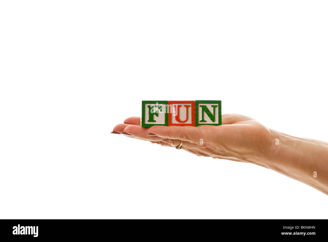 Woman holding children's blocks that spell 'FUN' Stock Photo