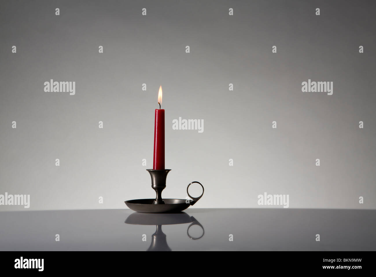 Chamberstick candle holder burning candle hi-res stock photography