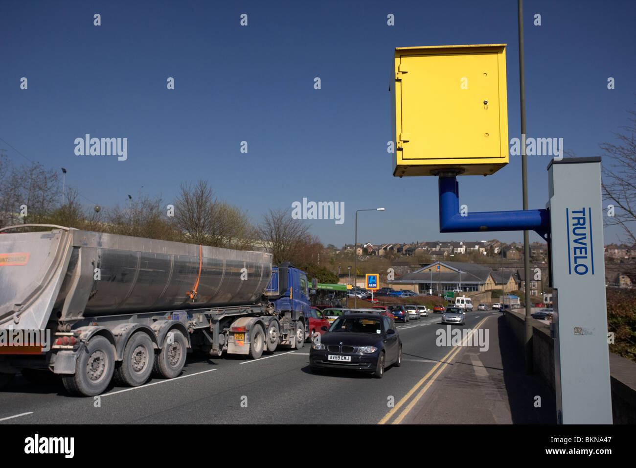 car passing yellow speed traffic camera on a road in Buxton Derbyshire England UK Stock Photo
