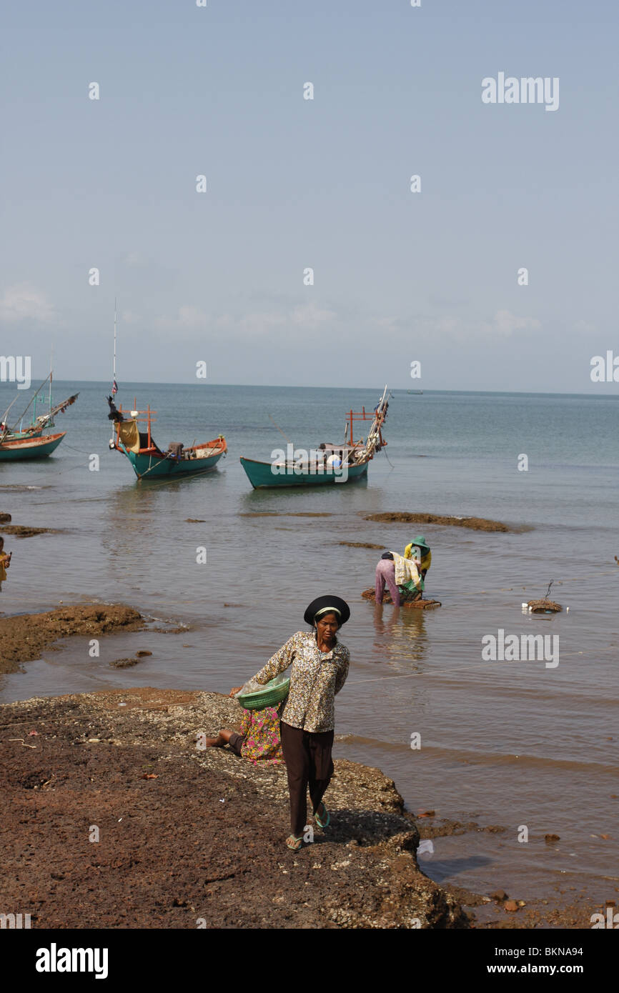 Early in the morning, long- tail fishing boats lie moored off the busy crab market in Kep, on Cambodia`s southeastern coast Stock Photo