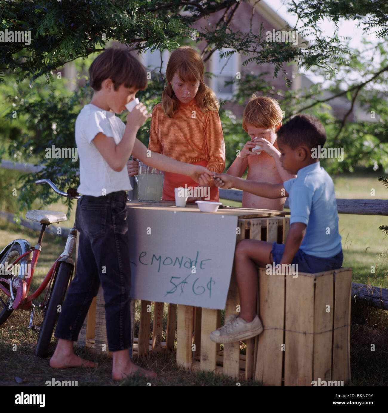 A 5-year old boy sits at a lemonade stand with cups and a pitcher of  lemonade Stock Photo - Alamy