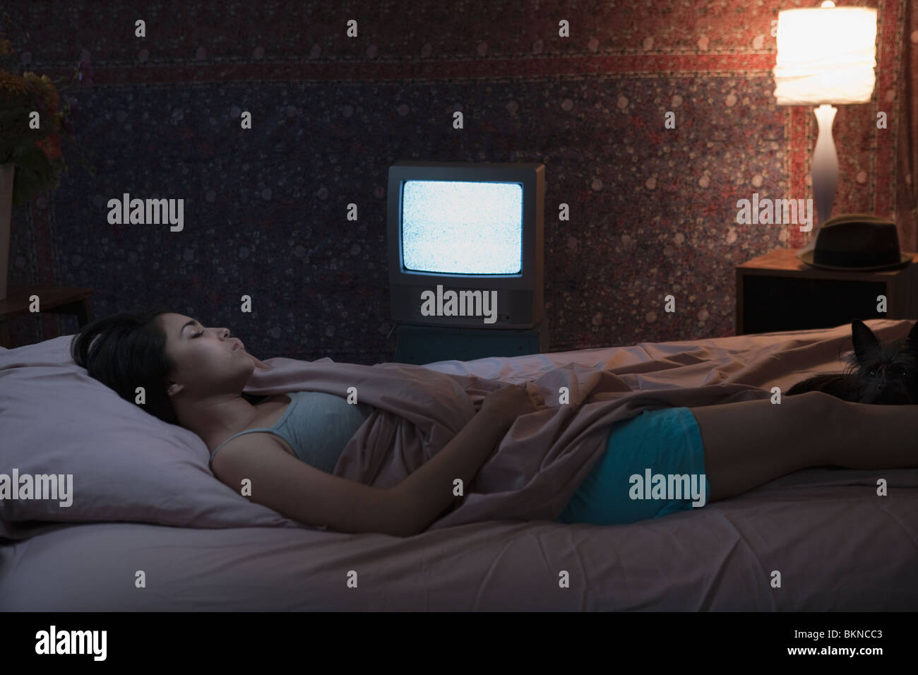 Hispanic woman sleeping with television on Stock Photo Alamy