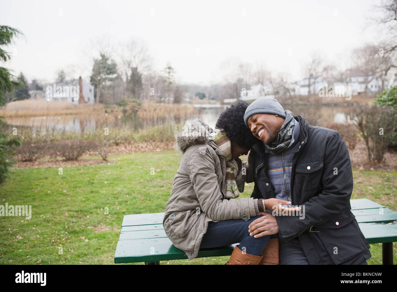 Couple laughing together in park Stock Photo - Alamy