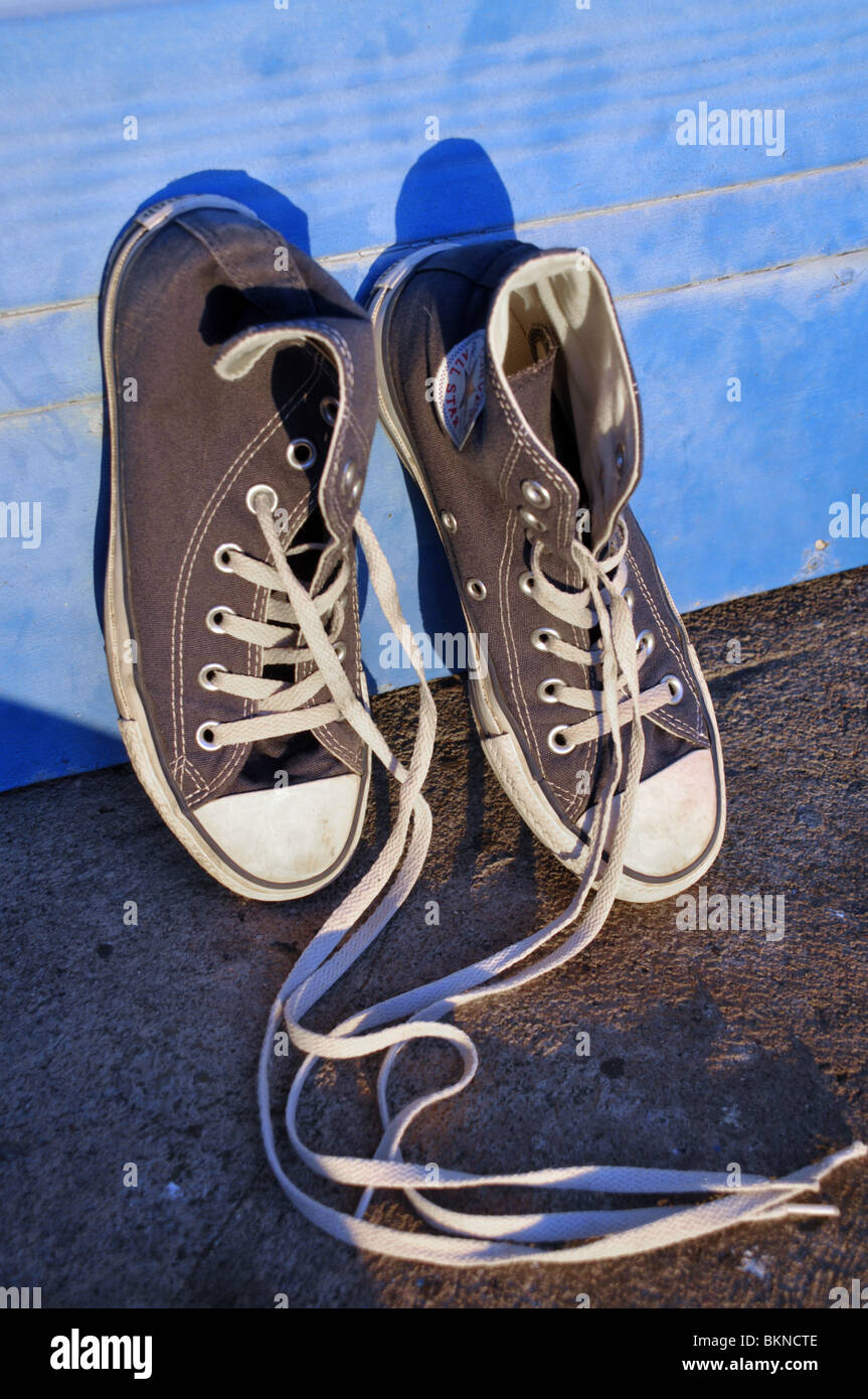 A pair of baseball / basketball trainers leaning against a door. Stock Photo