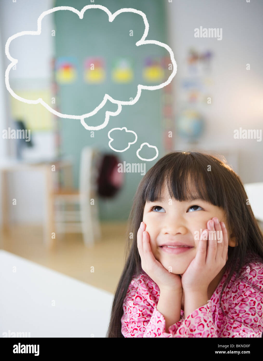 Chinese girl with thought bubble in classroom Stock Photo
