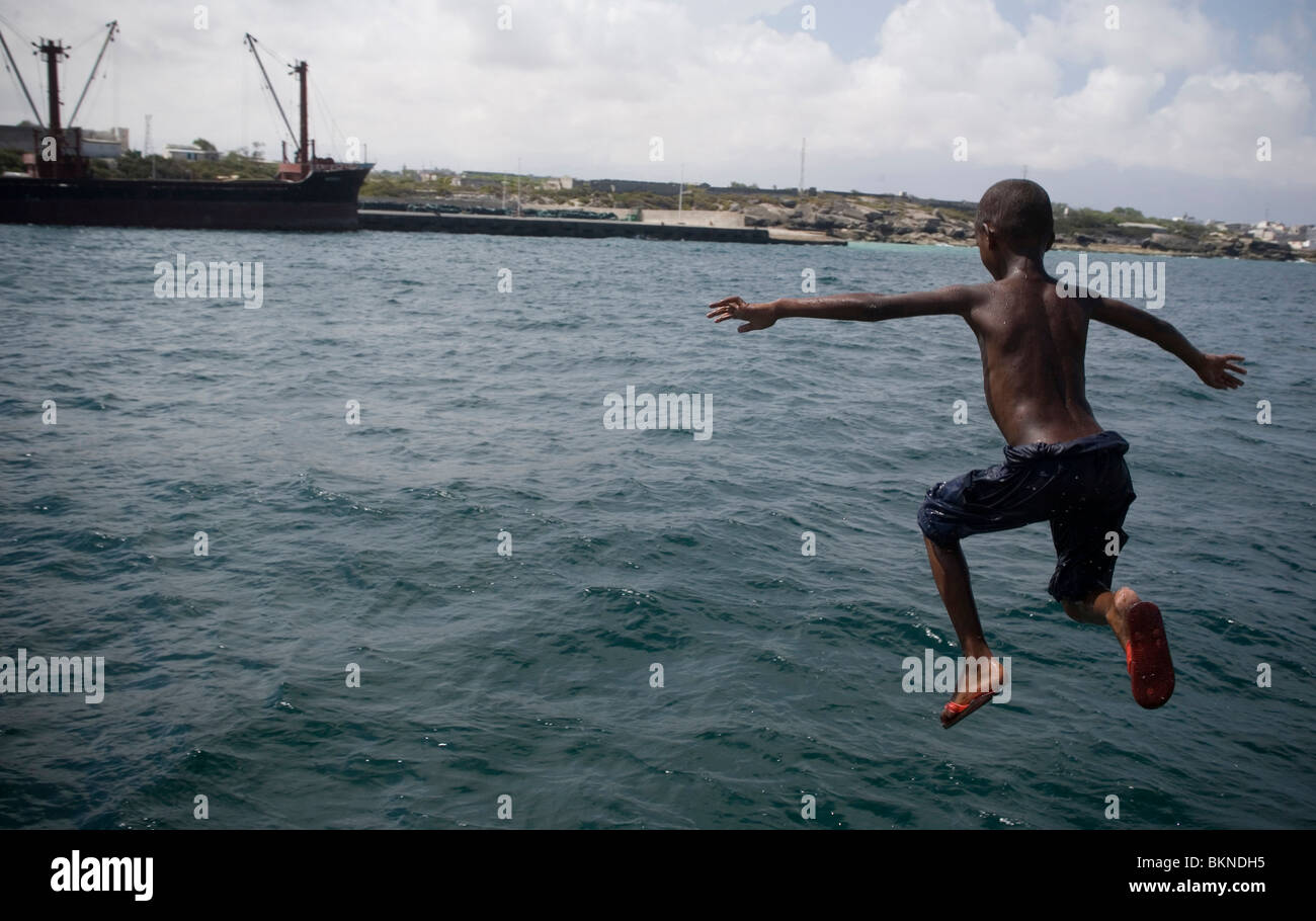 A child jumps into the sea from the port of the Somali capital Mogadishu on April 4, 2010. Stock Photo