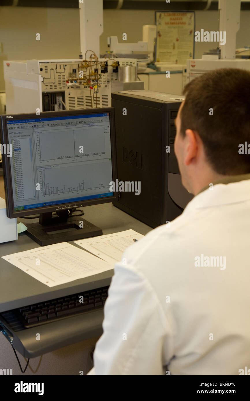 Forensic expert using gas chromatograph in forensic laboratory