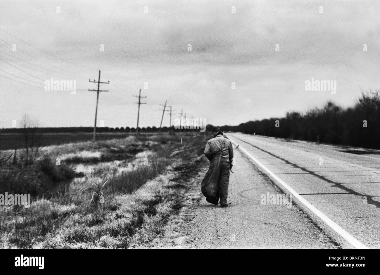 Homeless man collecting tin cans Black and White Stock Photos & Images