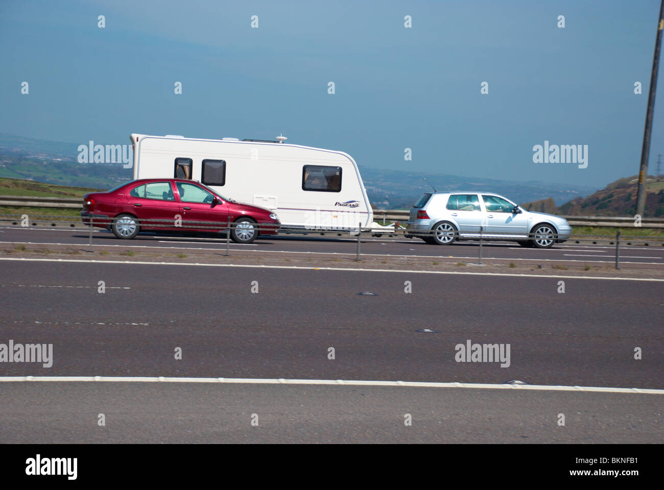 Car & caravan on the M62 (near Huddersfield). Stock Photo