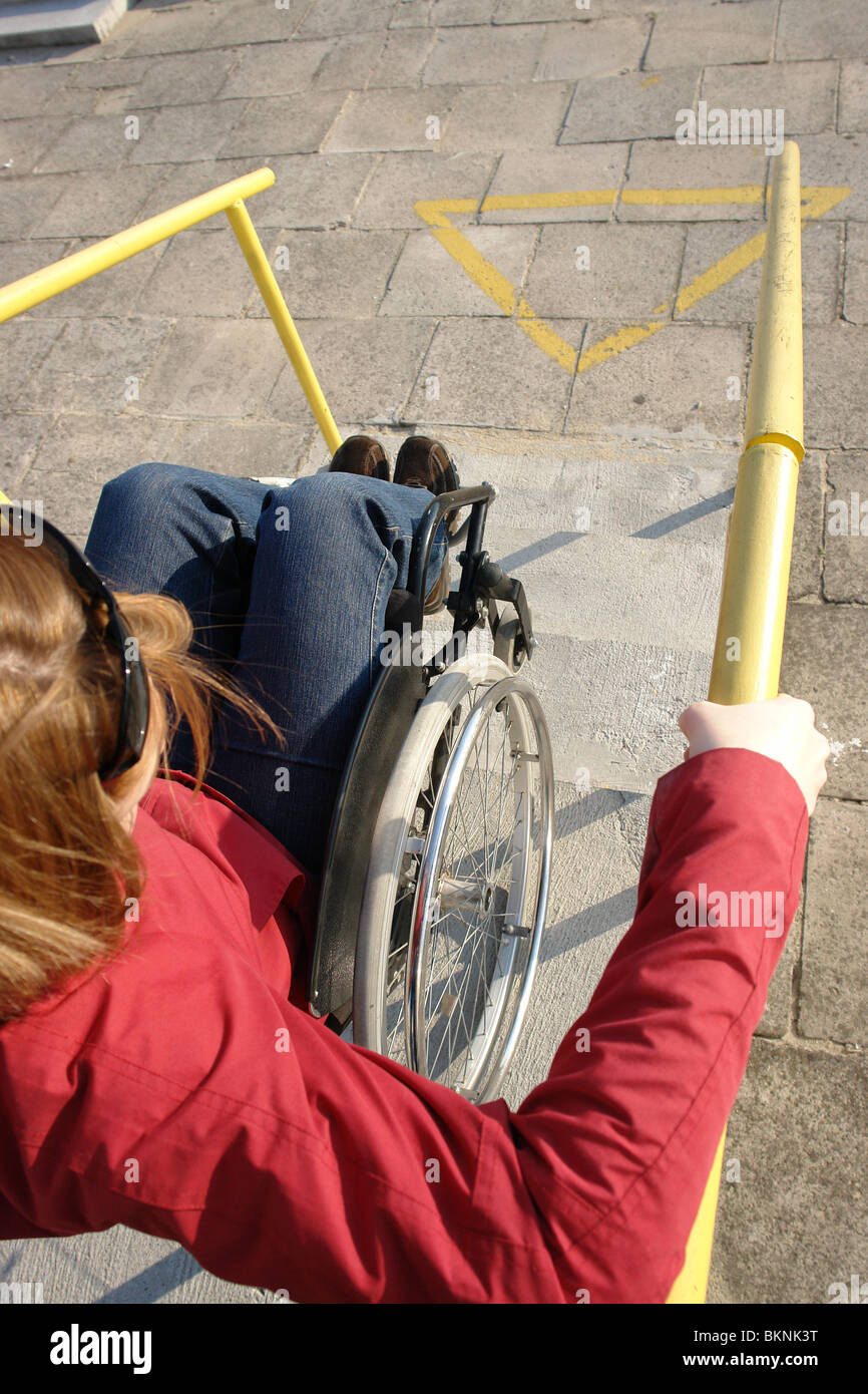 Closeup of wheelchair woman going down the concrete stairs Stock Photo