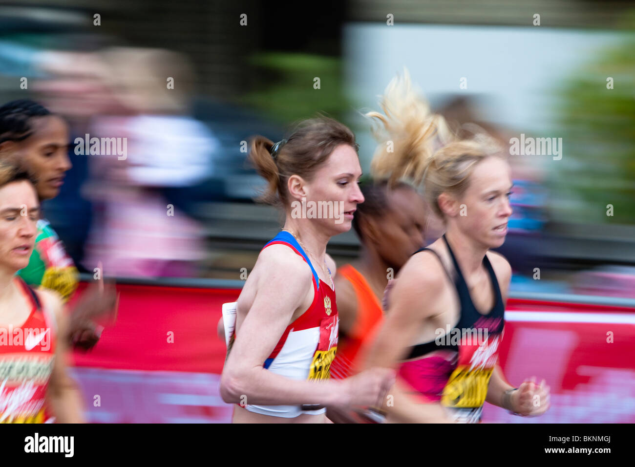 London Marathon 2010. In first mile the winner of the ladies race, Liliya Shobukhova (RUS) , runs in the pack next to Kim Smith. Stock Photo