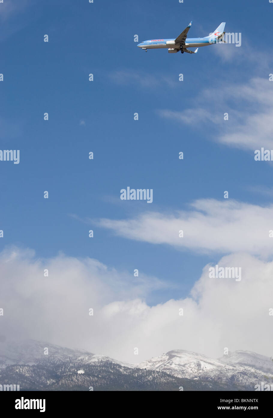 Airplane flying over mountain Tenerife. Clear blue sky with white