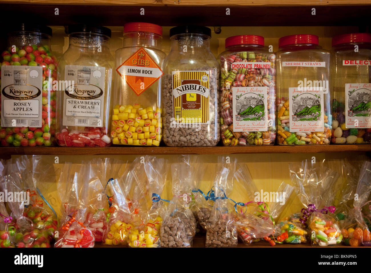 https://c8.alamy.com/comp/BKNPN5/old-fashioned-sweet-shop-boiled-sweets-jars-with-packets-of-confectionery-BKNPN5.jpg