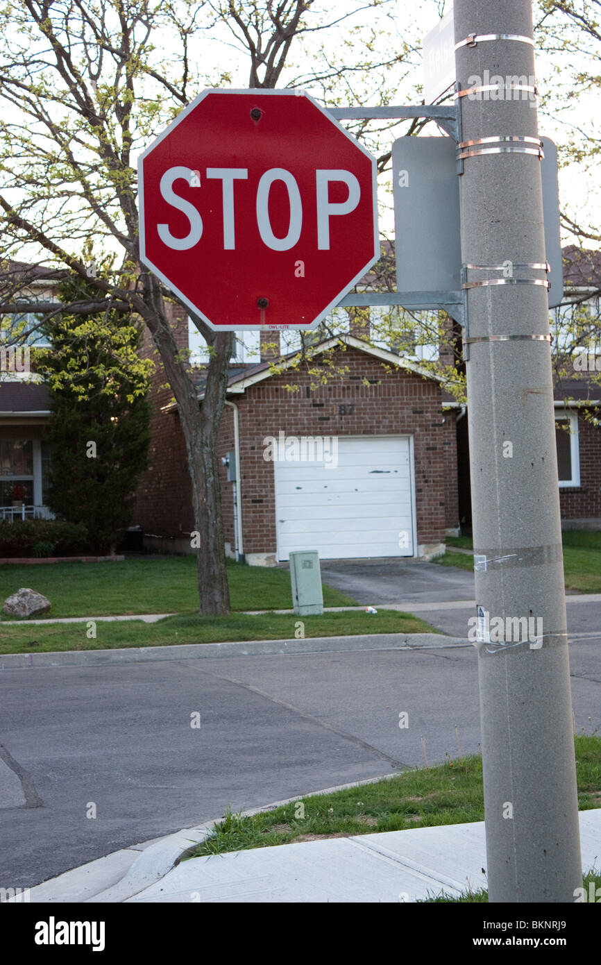 stop sign road house street pole residential Stock Photo