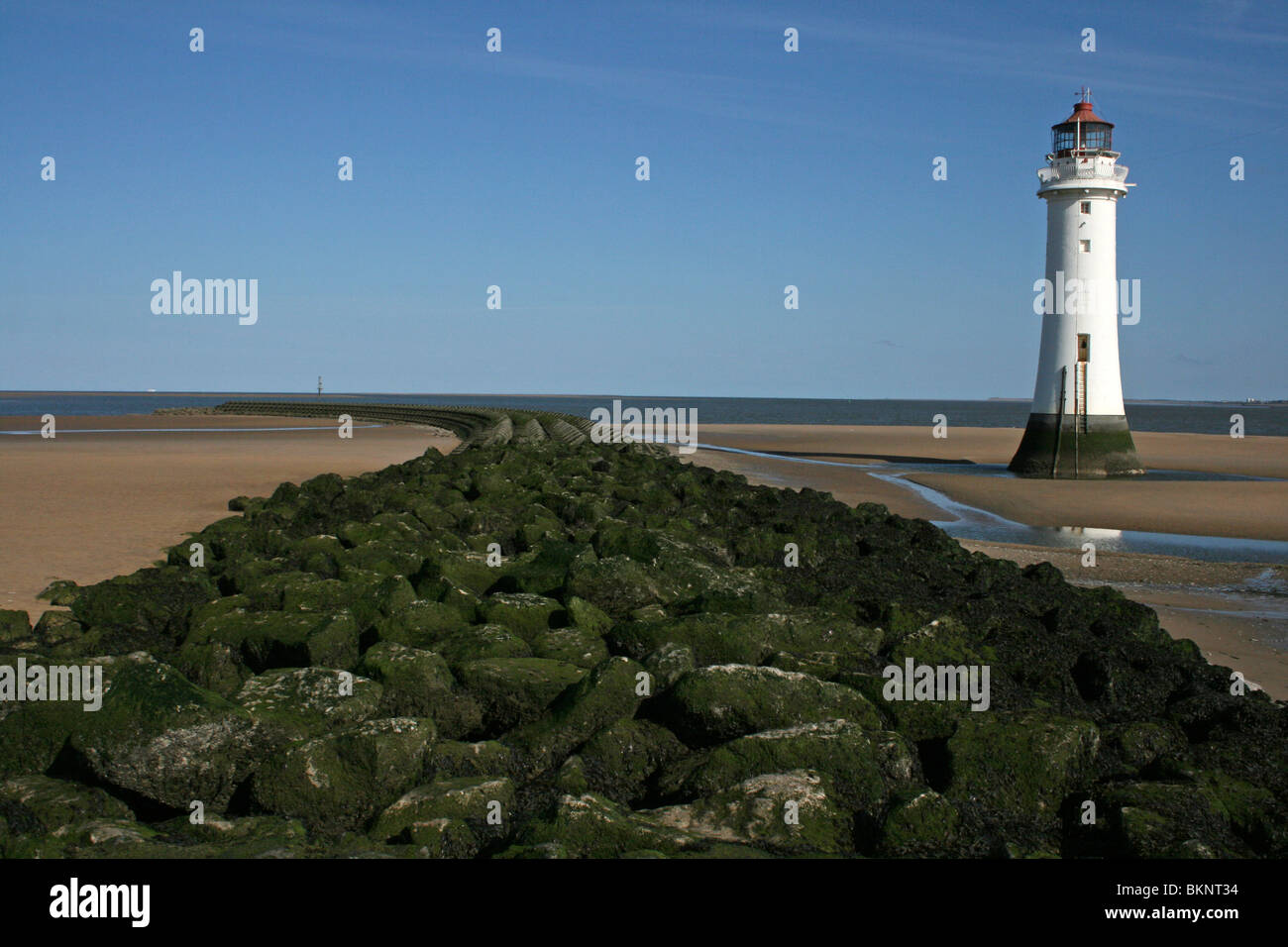 New Brighton Lighthouse Beside The Sea Defence Groyne, Wallasey, The Wirral, Merseyside, UK Stock Photo