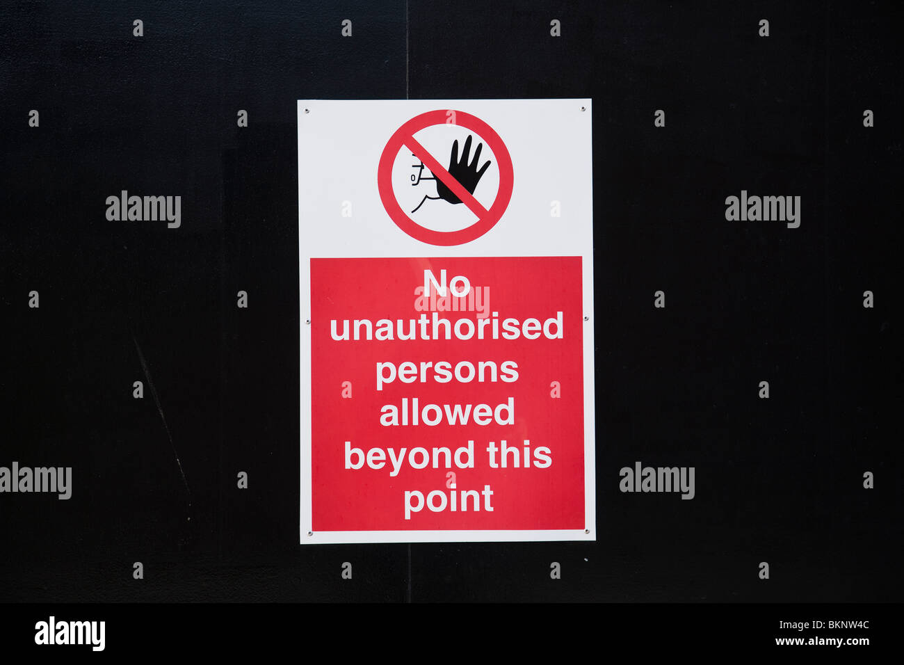 No unauthorised persons allowed beyond this point, red and white sign ...