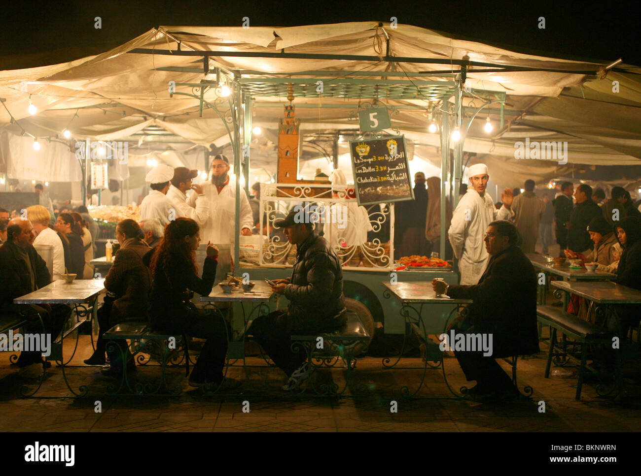 Evening diners pictured at a food stall in the Djemaa el-fna square in Marrakesh, Morocco. Stock Photo